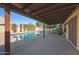 Covered patio with pool view, adjacent to grassy lawn at 5446 W Beryl Ave, Glendale, AZ 85302