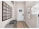 Bright and airy entryway with a white door and gray bench at 655 S First St, Coolidge, AZ 85128