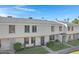 View of tan two-story townhomes with landscaping at 6623 S Palm Dr, Tempe, AZ 85283