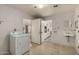 Bright laundry room with washer, dryer, and access to the kitchen at 666 N 65Th Pl, Mesa, AZ 85205