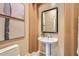 Modern powder room with pedestal sink and neutral color palette at 8336 E Sunnyside Dr, Scottsdale, AZ 85260