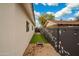 Landscaped side yard with artificial turf and cornhole at 8340 E Roma Ave, Scottsdale, AZ 85251