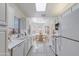 Galley kitchen with white cabinets, tile flooring, and breakfast nook at 8355 W Utopia Rd, Peoria, AZ 85382