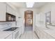 White kitchen with ample counter space, black appliances, and access to dining at 8355 W Utopia Rd, Peoria, AZ 85382