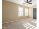 Spacious bedroom with neutral walls and carpet, featuring a ceiling fan and window with shutters at 990 E Doris St, Avondale, AZ 85323