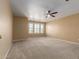 Spacious bedroom with carpeted floors and ceiling fan at 990 E Doris St, Avondale, AZ 85323