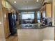 Kitchen boasts an island, wood cabinets, and black appliances at 11557 E Kilarea Ave, Mesa, AZ 85209