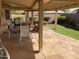 Covered patio with stone flooring and comfortable seating at 11557 E Kilarea Ave, Mesa, AZ 85209