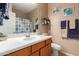 Bathroom with single sink vanity, shower/tub combo, and patterned shower curtain at 12006 W Vernon Ave, Avondale, AZ 85392