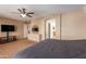 Primary bedroom with ensuite bathroom access and large TV at 12006 W Vernon Ave, Avondale, AZ 85392