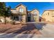 Two-story house with green shutters and a long driveway at 12006 W Vernon Ave, Avondale, AZ 85392