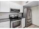 Modern kitchen with white cabinets, stainless steel appliances, and dark countertops at 1245 W 1St St # 114, Tempe, AZ 85281