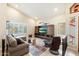 Living room with sectional sofa, large TV, and mid-century modern decor at 12810 S 41St St, Phoenix, AZ 85044