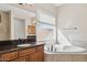 Bathroom with a soaking tub, double vanity, and dark countertops at 12860 W Calle De Sol --, Peoria, AZ 85383