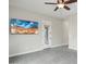 Bedroom with carpet flooring, large TV, and patio door access at 12860 W Calle De Sol --, Peoria, AZ 85383