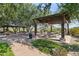 Relaxing pergola-covered patio area with picnic tables and benches at 12860 W Calle De Sol --, Peoria, AZ 85383