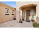 Front courtyard with brick pavers, potted plants, and a wooden door at 12860 W Calle De Sol --, Peoria, AZ 85383