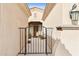 gated courtyard entry with brick pavers and potted plants at 12860 W Calle De Sol --, Peoria, AZ 85383