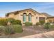 Tan house with a brown door and two car garage, and desert landscaping at 12860 W Calle De Sol --, Peoria, AZ 85383