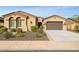 Tan house with a brown door and two car garage and desert landscaping at 12860 W Calle De Sol --, Peoria, AZ 85383