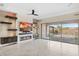 Living room with a fireplace, TV, and sliding doors to a backyard pool at 12860 W Calle De Sol --, Peoria, AZ 85383