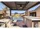 Modern outdoor kitchen with built-in grill and poolside access at 12860 W Calle De Sol --, Peoria, AZ 85383