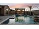 Luxury pool area with pergola, fountain features, and built-in BBQ at 12860 W Calle De Sol --, Peoria, AZ 85383