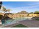 Relaxing pool area with brick patio, water features, and mountain views at 12860 W Calle De Sol --, Peoria, AZ 85383