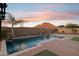 Stunning sunset view of the backyard pool and patio at 12860 W Calle De Sol --, Peoria, AZ 85383