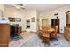 Bright dining room with wooden table and chairs, office space, and kitchen view at 13844 N 111Th Ave, Sun City, AZ 85351