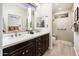 Double vanity bathroom with large shower and linen closet at 16232 W Silver Falls Dr, Surprise, AZ 85374