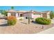 Single-story home with solar panels, desert landscaping, and a two-car garage at 16232 W Silver Falls Dr, Surprise, AZ 85374