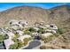 Aerial view of community featuring multiple buildings, pool, and surrounding desert landscape at 1716 W Cortez St # 116, Phoenix, AZ 85029