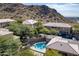 Aerial view of community pool and surrounding buildings with mountain backdrop at 1716 W Cortez St # 116, Phoenix, AZ 85029