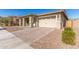 Front view of a single story home with a paved driveway at 21168 W Windsor Ave, Buckeye, AZ 85396