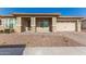 Single-story home with a two-car garage and landscaped front yard at 21168 W Windsor Ave, Buckeye, AZ 85396