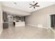 Open concept living room and kitchen with tile floors and modern kitchen island at 29411 W Mitchell Ave, Buckeye, AZ 85396