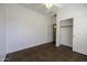 Bedroom with ceiling fan, closet and access to hallway at 45142 W Windrose Dr, Maricopa, AZ 85139