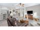 Living room with hardwood floors, leather sofas, and a rustic wooden coffee table at 4741 E Timberline Rd, Gilbert, AZ 85297