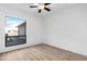 Bright bedroom with large window and wood-look floors at 5311 W Mountain View Rd, Glendale, AZ 85302