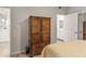 Bedroom with wooden armoire and access to bathroom at 7009 E Acoma Dr # 1105, Scottsdale, AZ 85254