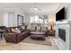 Living room with leather sofa, fireplace, and large TV at 7009 E Acoma Dr # 1105, Scottsdale, AZ 85254