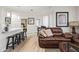 Light and airy living room with leather sofa and hardwood floors at 7009 E Acoma Dr # 1105, Scottsdale, AZ 85254