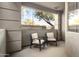 Private patio with comfortable seating and view of trees at 7009 E Acoma Dr # 1105, Scottsdale, AZ 85254
