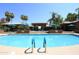 Community pool with plenty of lounge chairs and umbrellas at 7009 E Acoma Dr # 1105, Scottsdale, AZ 85254