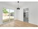 Open dining area with sliding glass doors leading to the backyard and modern light fixture at 7757 N 18Th Ave, Phoenix, AZ 85021