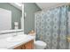 Clean bathroom with white vanity, shower, and patterned curtain at 8500 E Southern Ave # 368, Mesa, AZ 85209