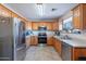 L-shaped kitchen with stainless steel appliances at 8926 E Malorie Ln, Coolidge, AZ 85128