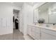 Modern bathroom with double vanity, large mirror, and walk-in shower at 9316 S 39Th Dr, Laveen, AZ 85339