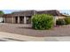 Ranch-style home with a double garage and mature shrubs at 9402 W Briarwood N Cir, Sun City, AZ 85351